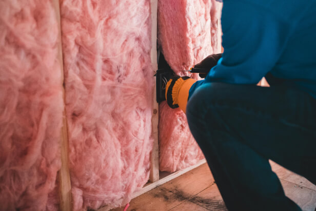 Homeowner reviewing finished insulation results at home