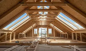 Attic under renovation with exposed wooden rafters